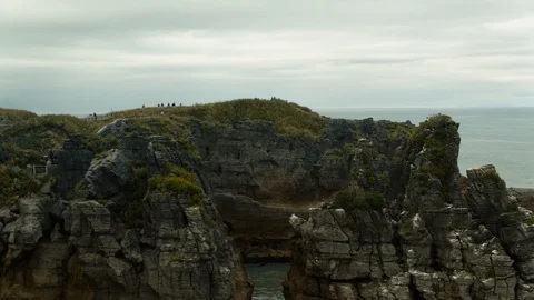 Drone shot couple walking on Pancake Rocks lookout at Punakaiki Stock Footage 89998461