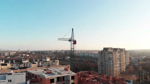 Drone shot of a crane boom or boom at a construction site during sunset Stock Footage 144785225