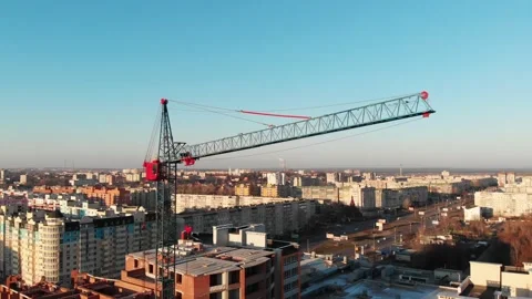 Drone shot of a crane boom or boom at a construction site during sunset Stock Footage 144785333