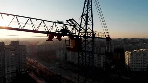 Drone shot of a crane boom or boom at a construction site during sunset Stock Footage 144785463