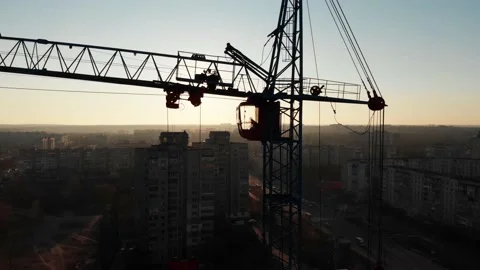 Drone shot of a crane boom or boom at a construction site during sunset Stock Footage 144785519