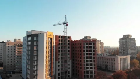 Drone shot of a crane boom or boom at a construction site during sunset Stock Footage 144785526