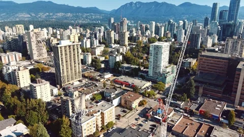 Drone Shot of Cranes Building New Towers in Vancouver's West End Vídeos de archivo 345983840