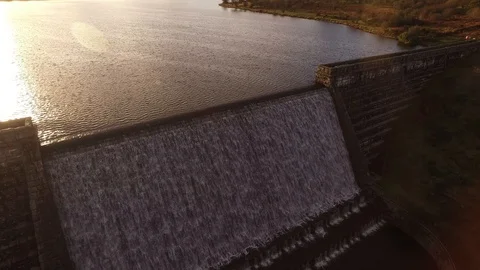 Drone shot of dam wall and sun reflecting on the lake Stock Footage 96154580