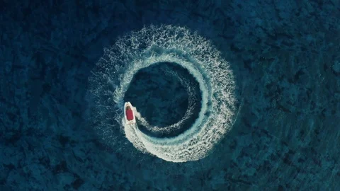 Drone shot descending towards fast speedboat going around in the circle Stock Footage 117139336