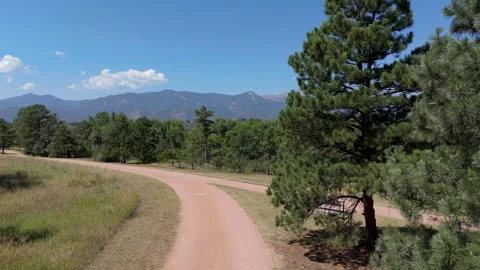Drone shot of Dirt Path with Pikes Peak in Background Stock Footage 315527333