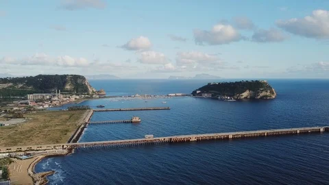 Drone shot of distant island in evening Video stock 127973490