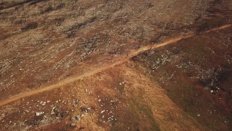 Drone shot of distant view of man running along path in natural setting, Cascais 스톡 동영상 114851784