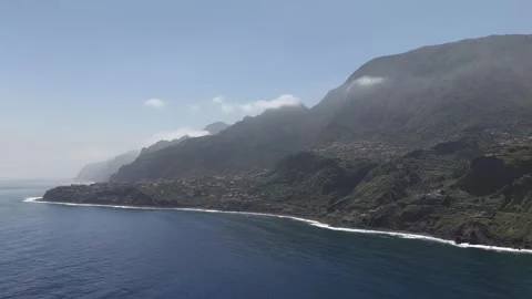 Drone Shot of Dramatic Aerial View of Madeira Island's Rugged Green Coastline Видео 345019789