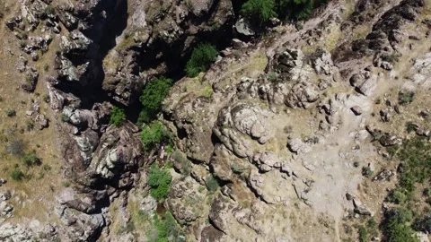Drone shot of dramatic canyon crevice and volcanic rock plates in Kazakhstan Stock Footage 338114347