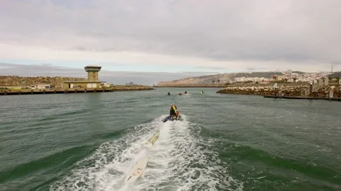 Drone shot of driver having surfboards tied to back of jet ski and driving Stock Footage 163283918