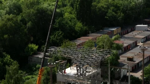 Drone shot of electric substation construction with mobile crane tilting down Stock Footage 339794847