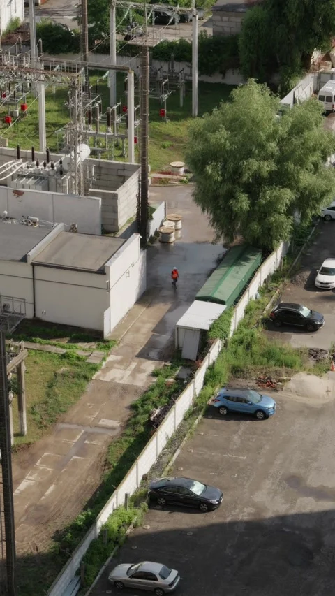 Drone shot of electrical engineer walking at power substation Stock Footage 340610581