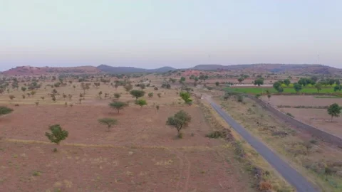 Drone shot of empty fields and village road in rajsthan india Stock Footage 236975624