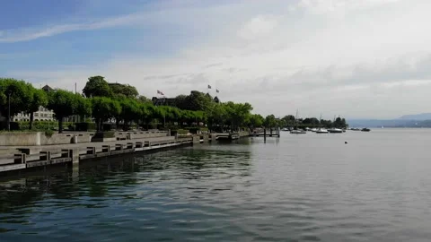 Drone Shot of Empty Lake Promenade During a Sunny Day in Zürich Видео 130341764