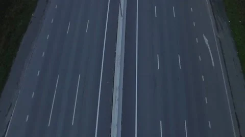 Drone shot of empty road wind between citycape on cloudy foggy day. Autumn Stockbeeldmateriaal 144262155