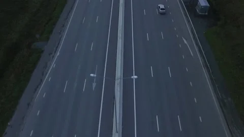 Drone shot of empty road wind between citycape on cloudy foggy day. Autumn Stock Footage 144367976