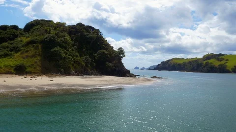Drone shot empty sandy beach surrounded by green hills Stock Footage 88608745