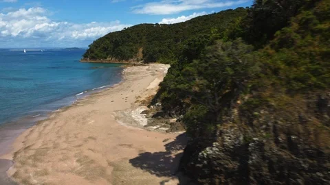 Drone shot empty sandy beach surrounded by green hills Stock Footage 88608915