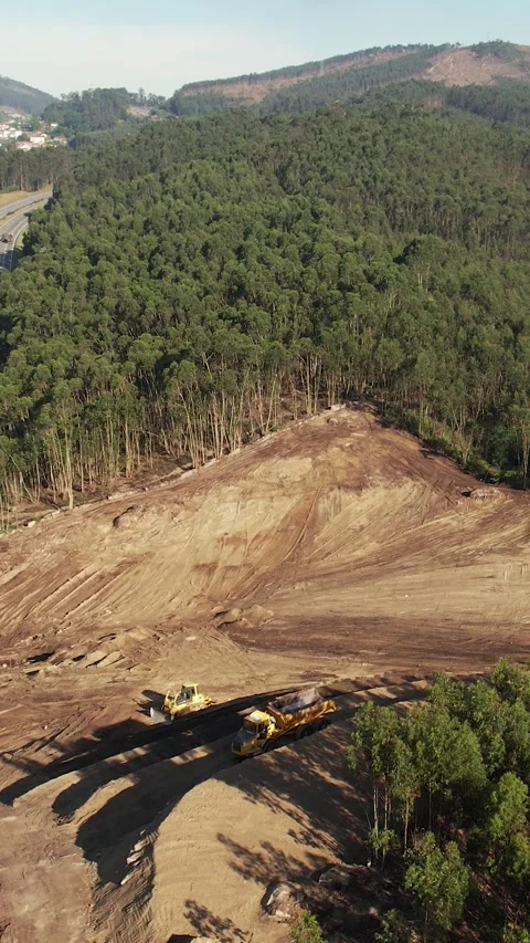 Drone Shot of an excavator operating on a hillside Stockbeeldmateriaal 336327405