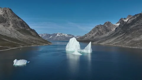 Drone shot of an extremely large iceberg drifting in East Greenland fjord Video stock 332368675