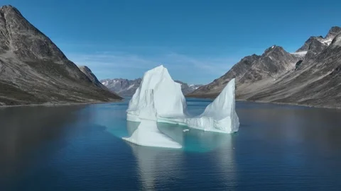 Drone shot of an extremely large iceberg drifting in East Greenland fjord Stock Footage 332382356