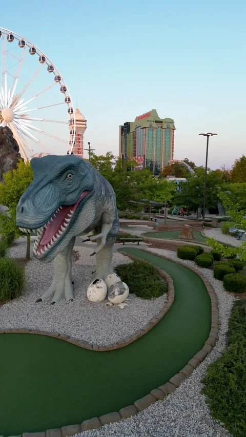 Drone Shot Featuring Giant Dinosaur Statue at Clifton Hill Attraction in Niagara Stock-Footage 330450798