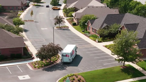 Drone shot. Fedex white courier van delivering mail and parcels to their Stock Footage 248553613