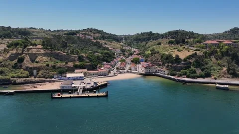 Drone shot of the ferry point and the tiny beach at Porto Brandao, 動画素材 249530775