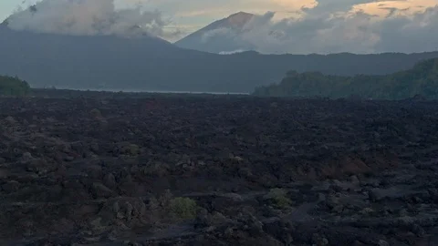 Drone shot of fields of frozen lava at the foot of the volcano Stock Footage 112739375