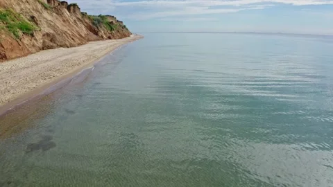 Drone shot of the flight over the shoreline with cliff Stock Footage 158184964