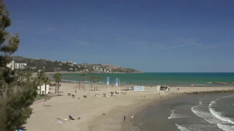 Drone shot floating over beach front towards clear blue sea Stock-Footage 150403302