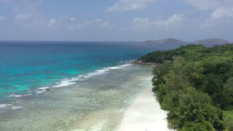 Drone shot: Flying above the Anse Severe beach on La Digue island, Seychelles 動画素材 105356511