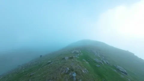 Drone shot flying above mountains in clouds and fog Video stock 252071904