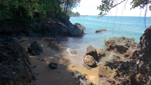 Drone shot, flying backwards over a beautiful cove beach Stock Footage 302691959