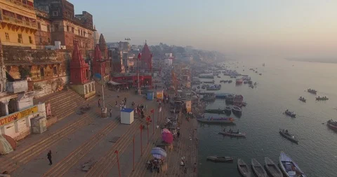 Drone shot flying down the crowded coastline of the city of Varanasi, Stock Footage 116901316