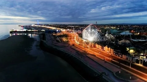 Drone shot flying down the promenade next to Blackpool pleasure beach. Stock Footage 139202609