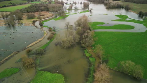 Drone Shot Flying Forward and Tilting Down Over Flooded Farmland, England Video stock 328521351