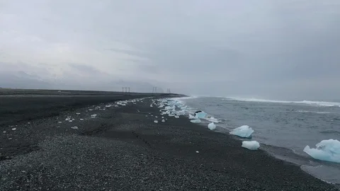 Drone shot, flying forward over the icebergs on Diamond beach, Iceland Stock Footage 112443657