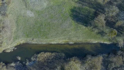 Drone shot flying forward on spring river in forest. Aerial view of spring Stock Footage 127702977