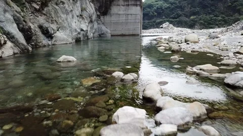 Drone shot flying low fast over clear river waters and rock formations (Taiwan)  Stock Footage 329052298