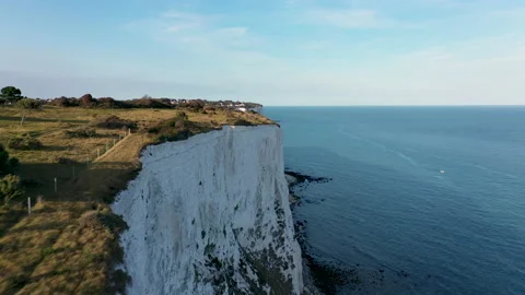 Drone shot flying low over white cliffs and the sea showing the coast. 4k Stock Footage