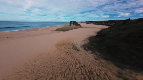 Drone shot flying low over dunes to beach Stock Footage 340905515