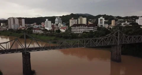 Drone shot flying over bridge on Itajaí-Açu River, Blumenau, Santa Catarina Stock Footage 317735776