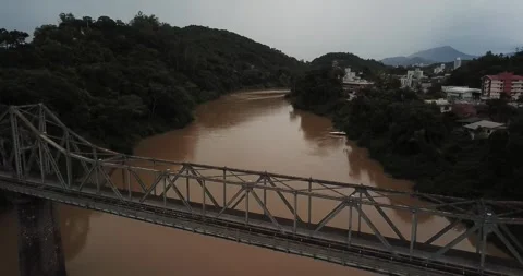 Drone shot flying over bridge on Itajaí-Açu River, Blumenau, Santa Catarina Stock Footage 317735887
