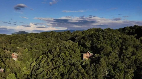 Drone shot flying over cabin nestled in the mountains Stock Footage 94136738