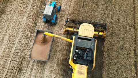 Drone shot flying over combine harvesters working Stock Footage 249281758