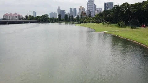 Drone shot flying over Kallang River with skyline in the background (Singapore) Stock Footage 329052010
