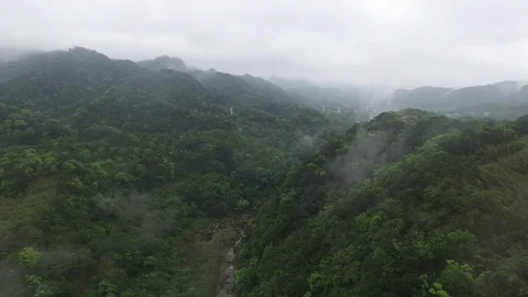 Drone shot flying over a mountain with a bridge in the background Stock Footage 85814143