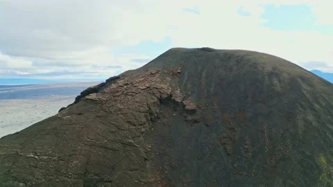 Drone shot flying over the mountain top made out of volcanic soil - somewhere in Stock Footage 233036764